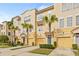 Three-story townhouses with attached garages and palm trees at 3117 Bayshore Oaks Dr, Tampa, FL 33611