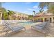 Community pool with lounge chairs and covered seating area at 3117 Bayshore Oaks Dr, Tampa, FL 33611