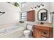Updated bathroom with a bathtub and wood vanity at 3621 Darston St, Palm Harbor, FL 34685