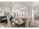 Open dining room with a farmhouse table and chairs, adjacent to kitchen at 3621 Darston St, Palm Harbor, FL 34685