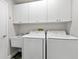 Laundry room with washer, dryer, and additional cabinets at 3621 Darston St, Palm Harbor, FL 34685