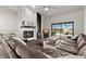 L-shaped sectional sofa anchors living room with fireplace and access to backyard at 3621 Darston St, Palm Harbor, FL 34685