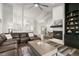 Open living area features a cozy fireplace, large sectional, and wood-look floors at 3621 Darston St, Palm Harbor, FL 34685