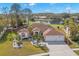 Single-story home with a two-car garage, mature landscaping, and a pond view at 3702 Gaviota Dr, Ruskin, FL 33573