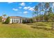 Large backyard with a screened pool and lush green grass at 3702 Gaviota Dr, Ruskin, FL 33573