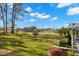 Landscaped backyard overlooking a peaceful pond and golf course at 3702 Gaviota Dr, Ruskin, FL 33573