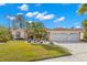 Single-story house with a two car garage and palm trees at 3702 Gaviota Dr, Ruskin, FL 33573
