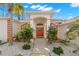 Inviting entryway with a red door and decorative landscaping at 3702 Gaviota Dr, Ruskin, FL 33573