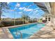 Inviting screened pool with a tiled border, perfect for enjoying Florida sunshine at 3702 Gaviota Dr, Ruskin, FL 33573
