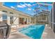 Relaxing screened pool area with patio furniture and grill at 3702 Gaviota Dr, Ruskin, FL 33573