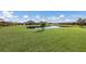 Homes surround a peaceful pond with lush green grass at 5211 Marina Basin Ct, Bradenton, FL 34211