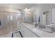 Modern bathroom with double sinks, granite countertops, and a walk-in shower at 5211 Marina Basin Ct, Bradenton, FL 34211