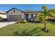 Single-story home with a two-car garage, landscaping, and a paved driveway at 5211 Marina Basin Ct, Bradenton, FL 34211