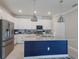 Modern kitchen with stainless steel appliances and a blue island at 5211 Marina Basin Ct, Bradenton, FL 34211