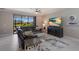Living room features a sectional sofa, large TV, and sliding glass doors at 5211 Marina Basin Ct, Bradenton, FL 34211