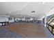 Spacious community room with hardwood floors, ample seating, and a piano at 6009 Sea Ranch Dr # 303, Hudson, FL 34667