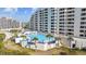 Inviting pool and patio area next to condo building at 6009 Sea Ranch Dr # 303, Hudson, FL 34667