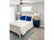 Comfortable main bedroom with a white bed frame and blue accents at 690 Fox St, Longboat Key, FL 34228