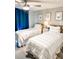 Guest bedroom with twin beds, coastal decor, and ceiling fan at 690 Fox St, Longboat Key, FL 34228
