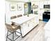 Modern kitchen with white shaker cabinets, large island, and quartz countertops at 690 Fox St, Longboat Key, FL 34228
