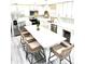Bright kitchen boasts white cabinets, a large island, and stainless steel appliances at 690 Fox St, Longboat Key, FL 34228