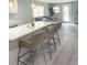 Modern kitchen with white cabinets, a large island, and stylish barstools at 690 Fox St, Longboat Key, FL 34228