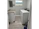 Clean laundry room with washer, dryer, and granite countertop at 690 Fox St, Longboat Key, FL 34228