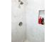 Clean shower with light gray tiles and a niche for toiletries at 690 Fox St, Longboat Key, FL 34228
