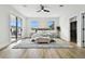 Spacious main bedroom with wood floors, a ceiling fan, and sliding glass doors to balcony at 808 W Adalee St, Tampa, FL 33603