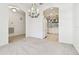 Bright dining room features a chandelier and an open view to the kitchen at 8529 Alexandra Arbor Ln, Temple Terrace, FL 33637