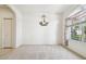 Simple dining area with neutral carpet and a lovely chandelier at 8529 Alexandra Arbor Ln, Temple Terrace, FL 33637