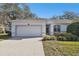 Well-maintained house featuring a garage and neatly kept front yard at 8529 Alexandra Arbor Ln, Temple Terrace, FL 33637