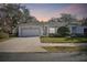 Inviting one-story home with a two-car garage and landscaped front yard at 8529 Alexandra Arbor Ln, Temple Terrace, FL 33637