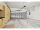 Garage with overhead door, storage cabinets and some floor stains at 8529 Alexandra Arbor Ln, Temple Terrace, FL 33637