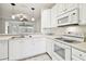 Bright kitchen features white cabinets, modern appliances, and a breakfast bar at 8529 Alexandra Arbor Ln, Temple Terrace, FL 33637