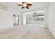 Living room with ceiling fan, carpet flooring, and access to a patio at 8529 Alexandra Arbor Ln, Temple Terrace, FL 33637