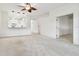 Spacious living area with a ceiling fan and access to other rooms at 8529 Alexandra Arbor Ln, Temple Terrace, FL 33637