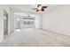 Bright living room with a ceiling fan and access to the patio at 8529 Alexandra Arbor Ln, Temple Terrace, FL 33637