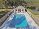 Community pool with lounge chairs and shaded seating area at 8529 Alexandra Arbor Ln, Temple Terrace, FL 33637