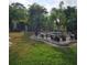 Lush landscaping with a fountain and seating area creates a tranquil backyard retreat at 901 8Th Sw St, Ruskin, FL 33570