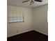 Bright bedroom with ceiling fan and dark carpeting at 901 8Th Sw St, Ruskin, FL 33570