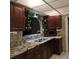 Kitchen with granite countertops and dark wood cabinets at 901 8Th Sw St, Ruskin, FL 33570