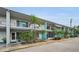Front view of a mid-century modern condo building with teal accents at 4140 55Th N St # 1211, Kenneth City, FL 33709