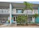 Two-story building with teal accents and a manicured front yard at 4140 55Th N St # 1211, Kenneth City, FL 33709