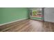 Light green living room with wood-look flooring and large windows at 4140 55Th N St # 1211, Kenneth City, FL 33709