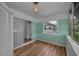 Bright sunroom features light wood floors and a refreshing teal wall at 4140 55Th N St # 1211, Kenneth City, FL 33709