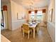 Light and airy dining area with a white table and yellow chairs at 10059 Crooked Creek Dr # 102, Venice, FL 34293