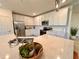 Kitchen island with white cabinets and quartz countertops at 10059 Crooked Creek Dr # 102, Venice, FL 34293