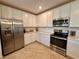 Modern kitchen with white cabinets and stainless steel appliances at 10059 Crooked Creek Dr # 102, Venice, FL 34293