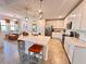 Open concept kitchen with white cabinets, an island, and stainless steel appliances at 10059 Crooked Creek Dr # 102, Venice, FL 34293
